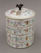 A 19th century Chinese four section porcelain food box. 16 cm high.