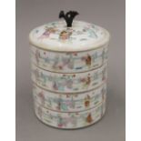 A 19th century Chinese four section porcelain food box. 16 cm high.