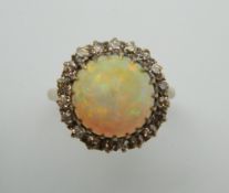 An 18 ct gold diamond and cabochon opal ring. Ring size O/P.