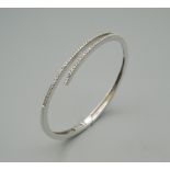 A 14 ct white gold and diamond bracelet. 6.5 cm wide. 13.8 grammes total weight.