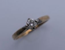 A 9 ct gold diamond solitaire ring. Ring size M/N. 1.9 grammes total weight.