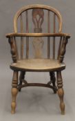 A 19th century child's elm seated Windsor chair. 65 cm high.