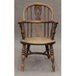 A 19th century child's elm seated Windsor chair. 65 cm high.