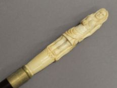 A bone handle walking stick, the handle formed as a lady. 99 cm long.