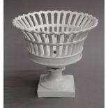 A white porcelain pierced fruit basket. 21 cm high.