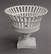 A white porcelain pierced fruit basket. 21 cm high.