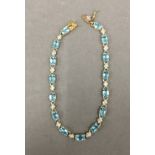 A 10 ct gold aquamarine and diamond bracelet. 17.5 cm long. 6 grammes total weight.