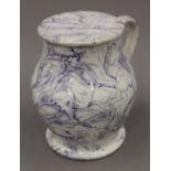 An early 19th century lidded porcelain tankard. 17 cm high.