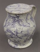 An early 19th century lidded porcelain tankard. 17 cm high.