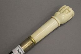A bone handle walking stick, the handle formed as a clenched fist. 92 cm long.