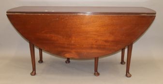 A mahogany pad foot drop leaf table. 167 cm long.