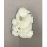 A white jade figural carving. 5.5 cm high.