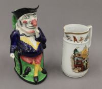 A Mr Punch toby jug and a Victorian jug decorated with Mr Punch and Toby. The former 26.5 cm high.