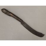 A tribal knife with figural carved wooden handle. 33 cm long.