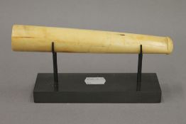 A late 19th century ivory pipe, on later stand. 18.5 cm long.