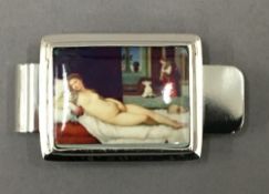 A sterling silver money clip decorated with a nude lady. 5 cm long.