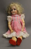 A large 19th century Simon and Halbig bisque headed doll. 59 cm tall.