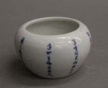 A small Chinese porcelain brush pot decorated with calligraphy. 5 cm high.