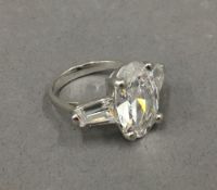 A silver three stone cubic zirconia ring