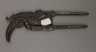 An Indonesian betel nut cutter formed as a hornbill. 21 cm long.