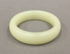 A jade bangle. 8 cm diameter.