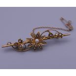 A 15 ct gold seed pearl set bar brooch. 4.5 cm wide. 3.7 grammes total weight.