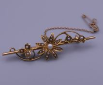 A 15 ct gold seed pearl set bar brooch. 4.5 cm wide. 3.7 grammes total weight.