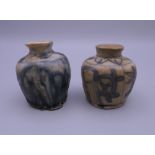 Two small early Chinese pottery ink pots. The largest 5 cm high.
