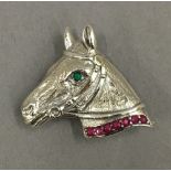 A silver horse brooch. 3.5 cm wide.