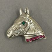 A silver horse brooch. 3.5 cm wide.