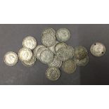 Twenty silver three pence coins,