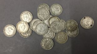 Twenty silver three pence coins,