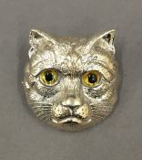 A silver cat brooch. 3 cm high.