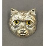 A silver cat brooch. 3 cm high.