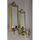 A pair of brass mirrored girandoles. 52 cm high, 23 cm wide.