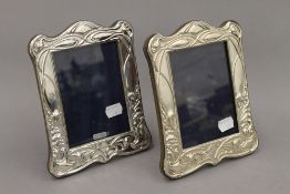 A pair of Art Nouveau style silver photograph frames. Each 20 cm high.
