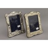 A pair of Art Nouveau style silver photograph frames. Each 20 cm high.