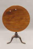 A George III mahogany tilt top tripod table. 76 cm diameter.