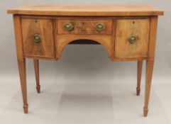 A Victorian inlaid mahogany bowfront sideboard. 107 cm wide.