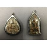 Two Asian icon pendants. The largest 7 cm high.