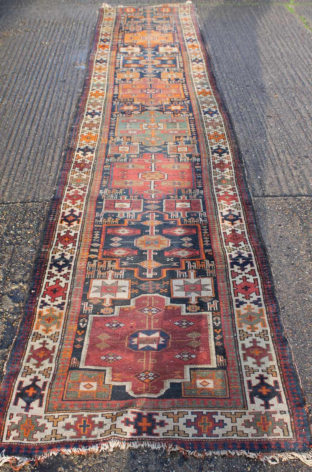 A large red ground runner. 100 x 484 cm.