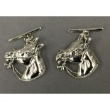 A pair of silver horse cufflinks. 2 cm high.