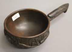 A carved wooden bowl with an eagle form handle. 18 cm diameter.