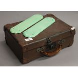 A pair of vintage green porcelain finger plates and a small vintage case.