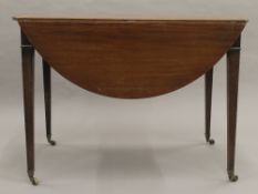 A mahogany Pembroke table. 59.5 cm wide flaps down.