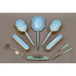 A quantity of enamel decorated silver dressing table wares. The largest 31 cm long.