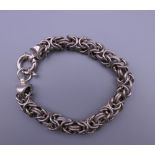 A silver ladies entwined link bracelet. 19 cm long. 31.2 grammes.