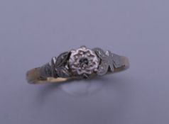 A 9 ct gold and platinum diamond solitaire ring. Ring size M/N. 2.2 grammes total weight.