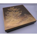 A Meiji Period Japanese lacquered artist's calligraphy box, the underside signed. 23.5 cm wide.