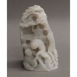 A Chinese white jade carved figural group. 11 cm high.